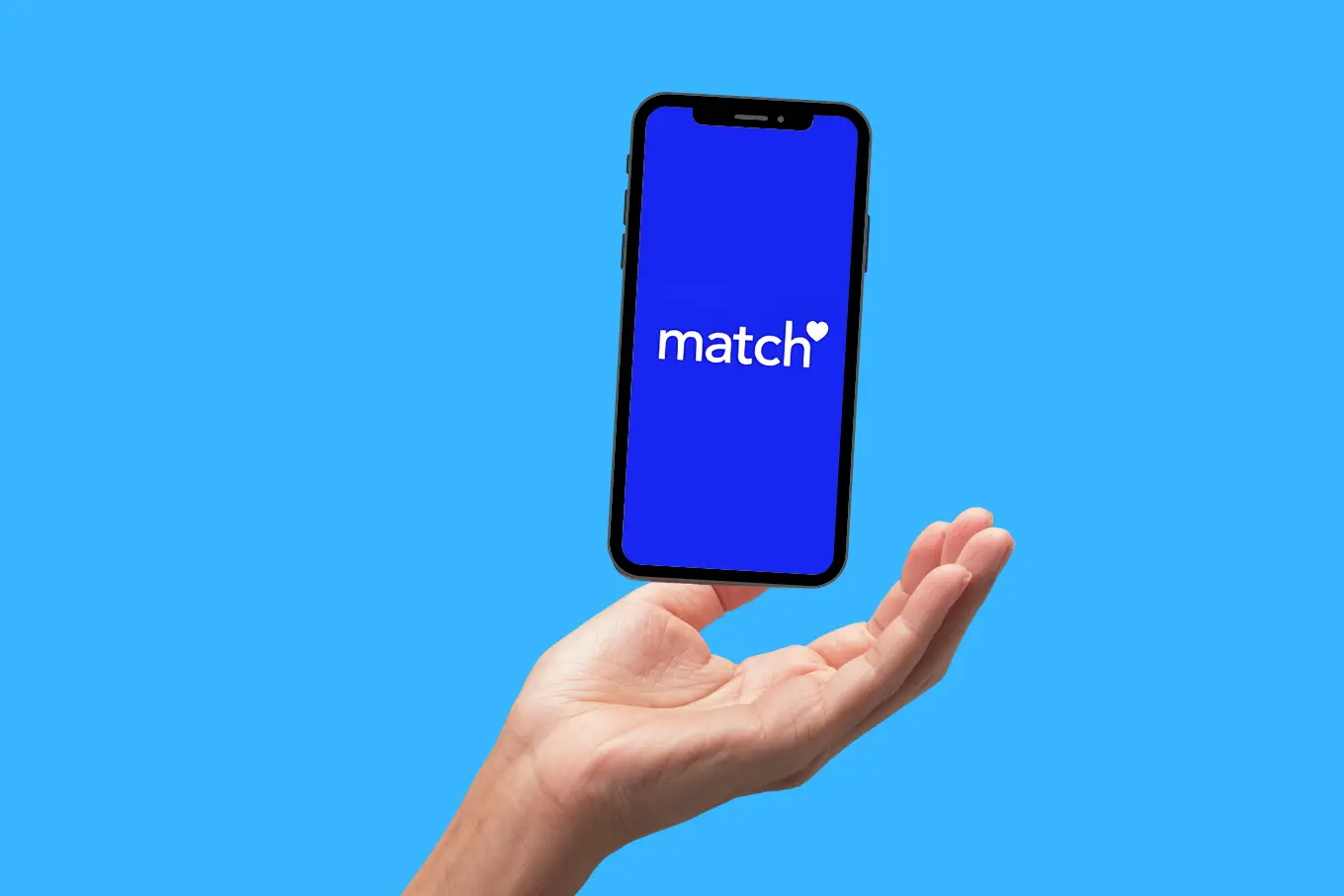 A hand is holding a smartphone against a bright blue background. The screen of the smartphone displays the word match with a small heart symbol